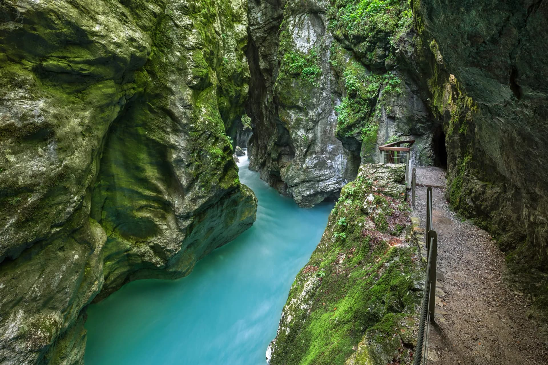 Tolmin Gorge in Triglav National Park with turquoise river and mossy canyon walls.